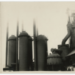 View of a furnace with large tanks and smokestacks