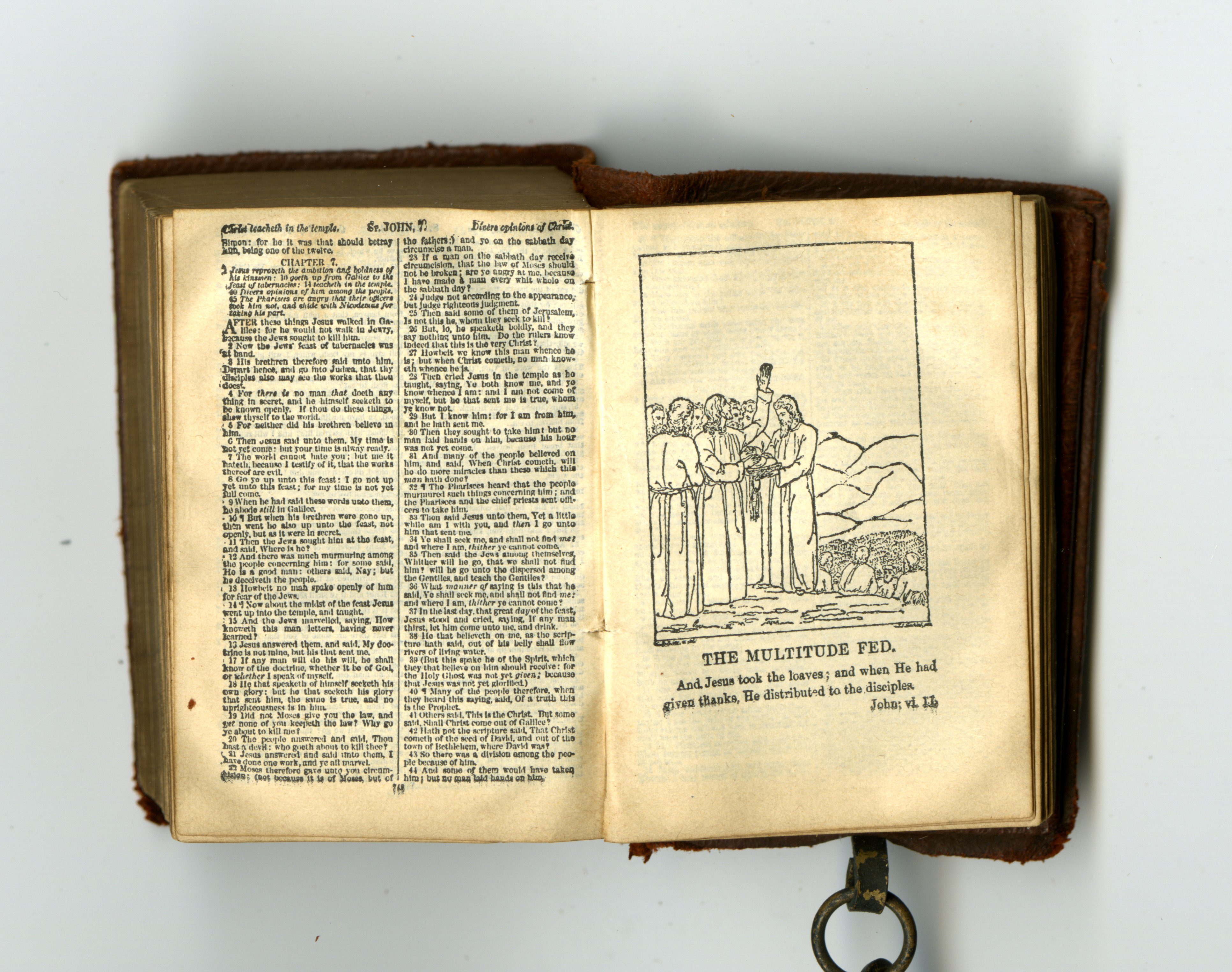 Page from John, featuring illustration of Jesus and disciples, from miniature Bible, published in Glasgow by David Bryce in 1901, attached to miniature lectern by a chain