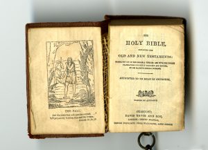 Title page of miniature Bible, published in Glasgow by David Bryce in 1901, attached to miniature lectern by a chain