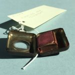 View of miniature Bible published by Frederick A. Stokes in New York in 189?, with item closed, inside its metal carrying case