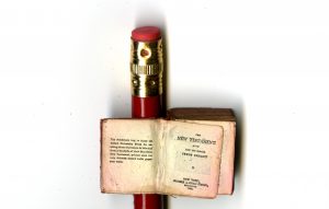 Pages from a miniature Bible published by Frederick A. Stokes in New York in 189? , with pencil eraser for size comparison