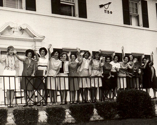 Pi Beta Phi sorority members waving in front of sorority house, circa 1965