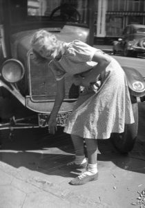 Elise Ayers in front of an automobile, early 1940s