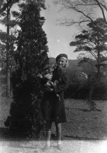 Elise Ayers holding a dog, late 1930s